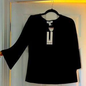 Black Nine West long sleeve top with silver ring accent on chest. NWT.